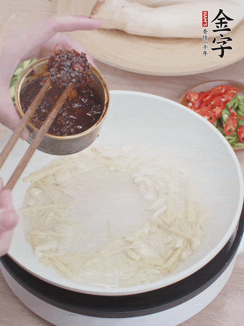 起鍋熱油，姜蒜、金字火腿干貝醬煸香。