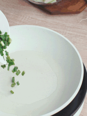 熱油下臘肉、蔥花煸炒，再下西葫蘆。